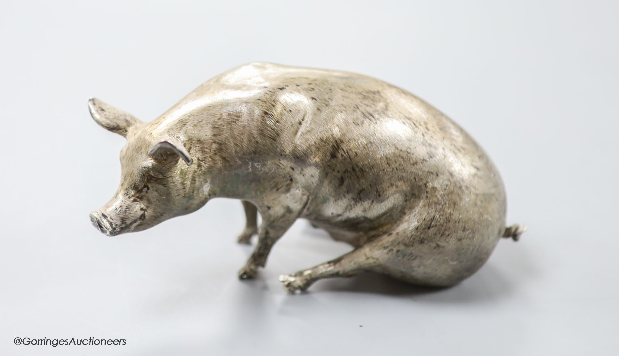 A modern silver miniature model of a seated pig, C.F.H & Co, London, 1993, height 65mm, 302 grams.